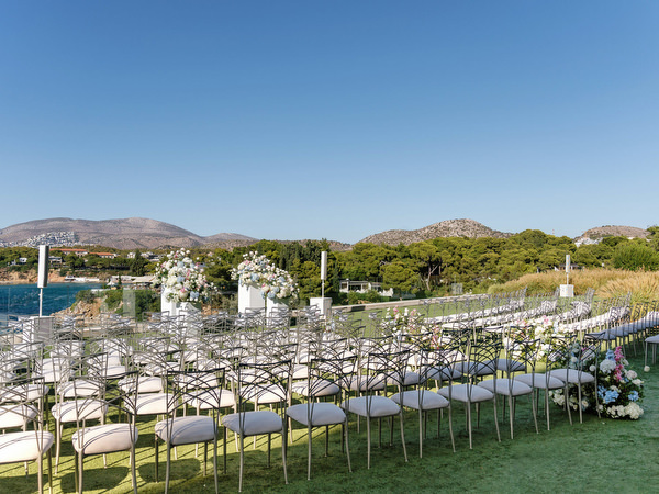 Floral-lined aisle for a black-tie wedding ceremony on the Athens Riviera