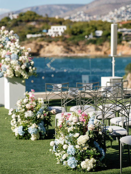 Pastel floral arrangements decorating a seaside wedding ceremony in Athens