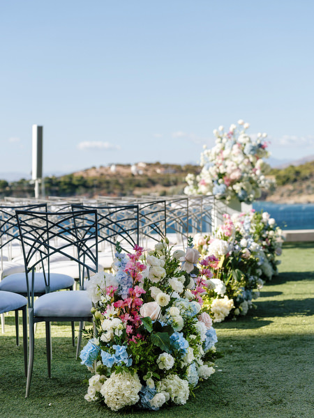 Wedding aisle florals leading to a seaside ceremony at Four Seasons Astir Palace