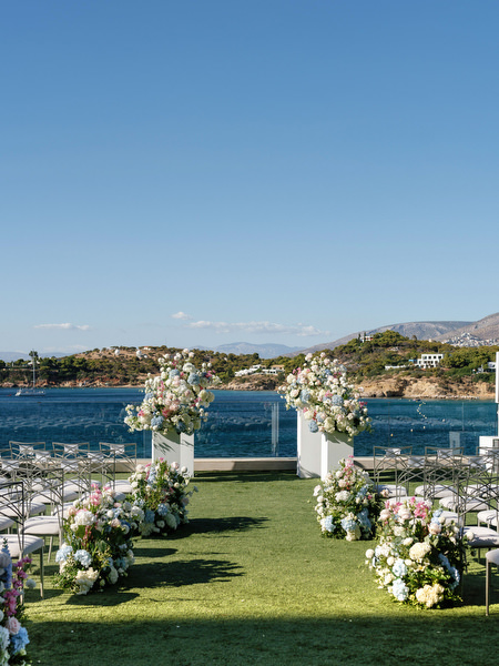 Floral wedding arch set for a seaside ceremony at Four Seasons Athens