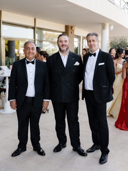 Black-tie wedding guests arriving at Four Seasons Astir Palace Athens