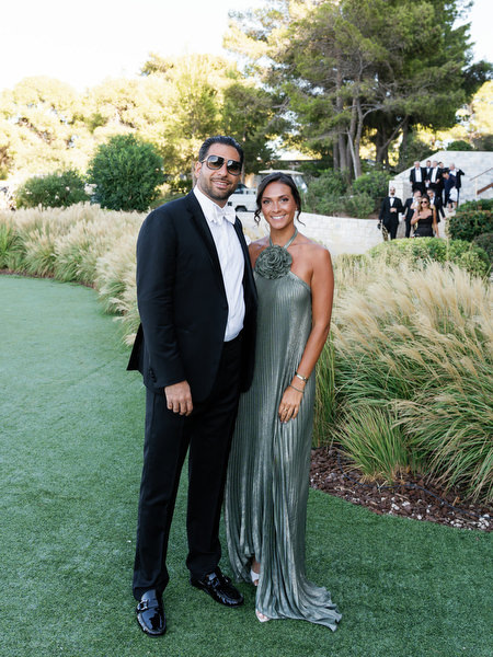 Wedding guests posing by the sea at Four Seasons Astir Palace