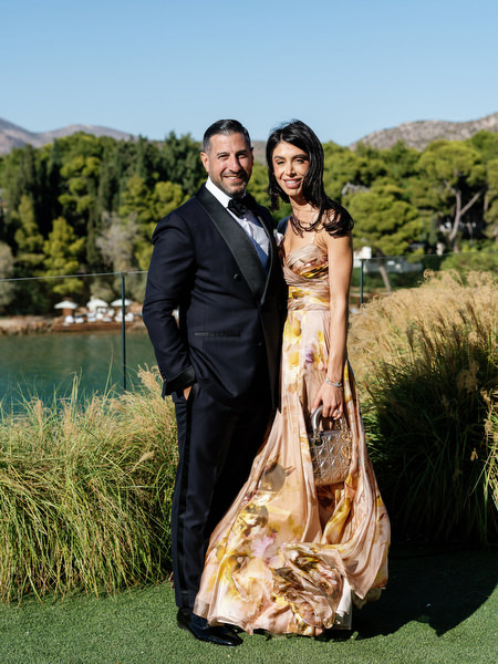 Black-tie wedding guests with Athens Riviera coastline backdrop