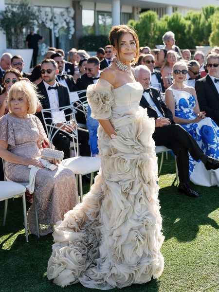 Elegant guest arriving at an Athens Riviera wedding ceremony
