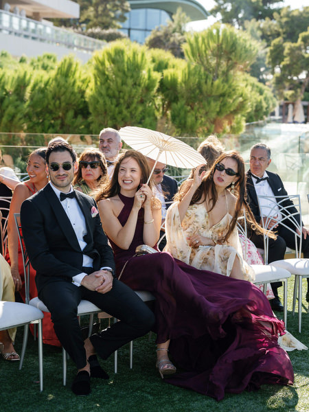 Black-tie guests seated at a seaside wedding ceremony at Four Seasons Astir Palace Athens