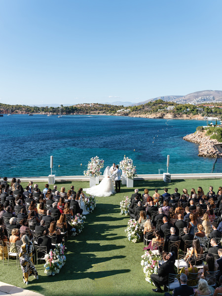 Outdoor wedding ceremony setup overlooking the turquoise Aegean Sea