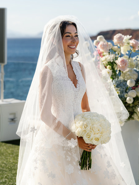 Bride portrait with veil and bouquet at Four Seasons Astir Palace overlooking the Aegean Sea