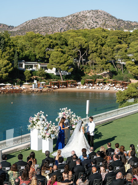 Bride and groom exchanging vows during a seaside ceremony on the Athens Riviera