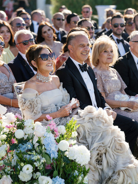 Family reacting during a black-tie Athens Riviera wedding ceremony