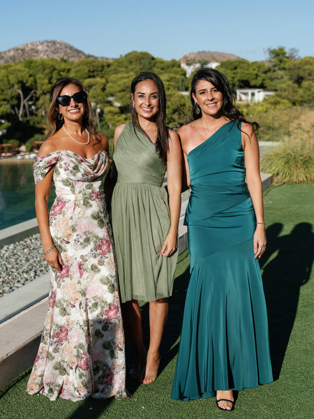 Wedding guests in evening attire overlooking the Aegean Sea in Athens