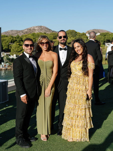 Black-tie wedding guests during cocktail hour at Four Seasons Astir Palace Athens