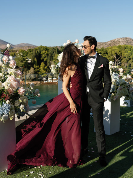 Guests posing by floral installations at a luxury Athens Riviera wedding