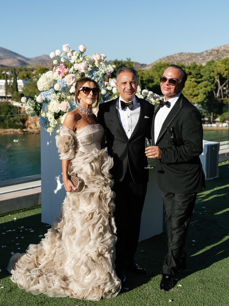 Black-tie wedding guests during cocktail hour on the Athens Riviera