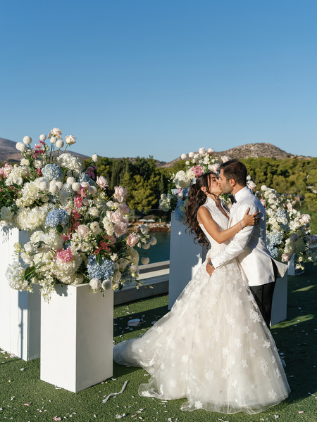 Bride and groom embracing at sunset during their Athens Riviera wedding
