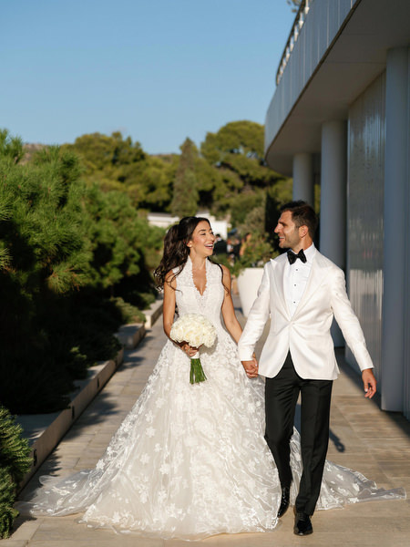Newlyweds walking at golden hour during their destination wedding in Athens