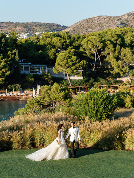 Bride and groom overlooking the Athens Riviera coastline at Four Seasons Astir Palace Athens