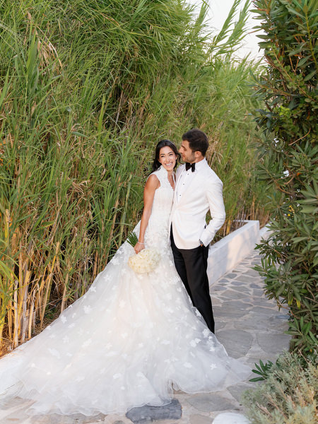 Bride and groom walking at sunset during their Island Resort Athens Riviera wedding