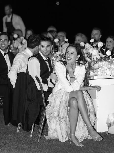 Black-and-white candid moment during Athens Riviera wedding reception