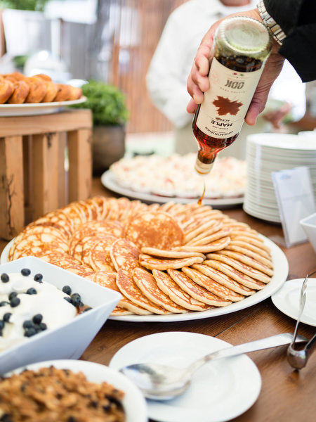 Dessert station with traditional sweets at Indian pre-wedding brunch