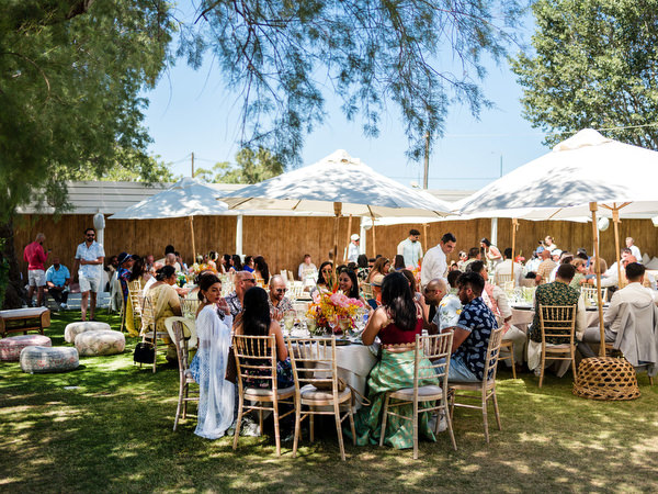 Wedding guests celebrating under pergola during Mehndi event