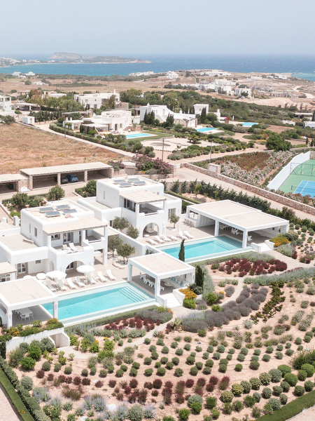 Aerial drone view of Petra Farm wedding venue in Paros overlooking the Aegean Sea.