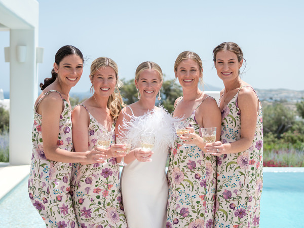 Bride and bridesmaids toasting before Orthodox wedding at Petra Farm Paros.