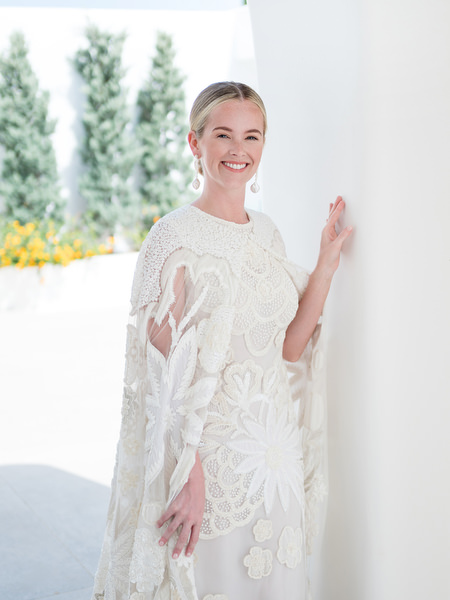 Bride smiling in natural light inside white villa at Petra Farm Paros.