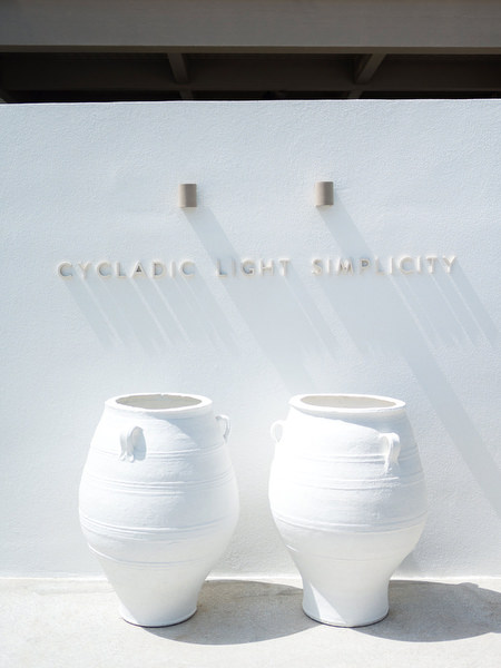 Minimal white ceramic vases at Petra Farm Paros wedding venue in the Cyclades.