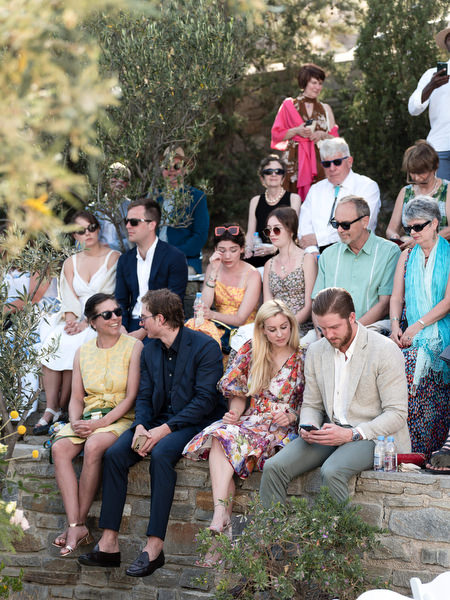 Guests seated outdoors at Petra Farm chapel ceremony in Paros Greece.
