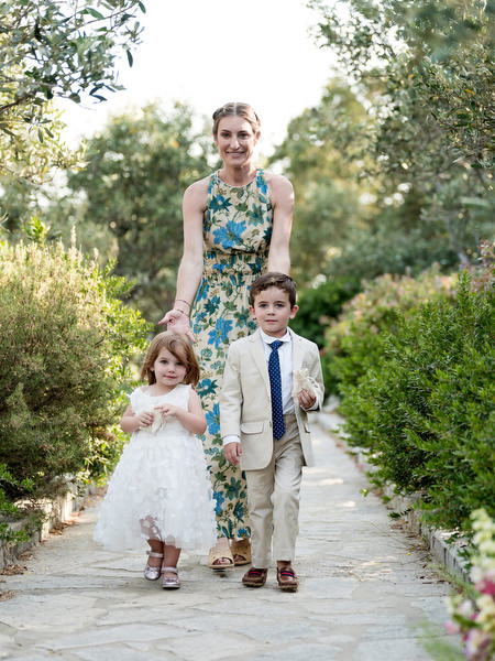 Children walking down aisle at Greek island wedding ceremony in Paros.