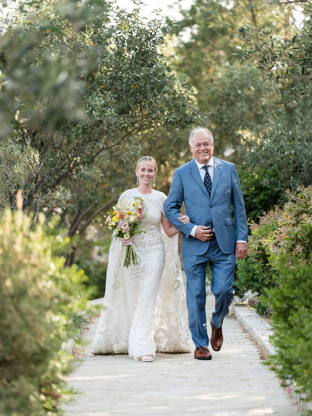 Bride walking down garden aisle with father at Petra Farm Paros wedding.