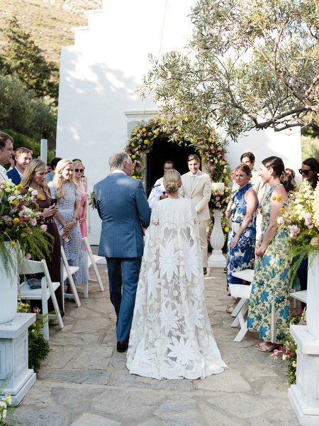 Bride walking down garden aisle with father at Petra Farm Paros wedding.