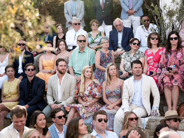 Guests seated outdoors at Petra Farm chapel ceremony in Paros Greece.