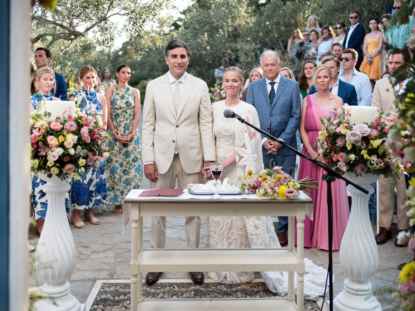 Outdoor Orthodox ceremony at Petra Farm chapel surrounded by olive trees in Paros.