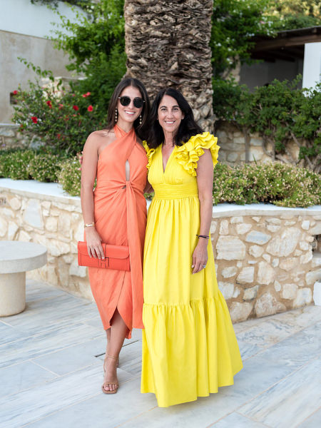 Wedding guests in colorful summer dresses at Paros destination wedding.
