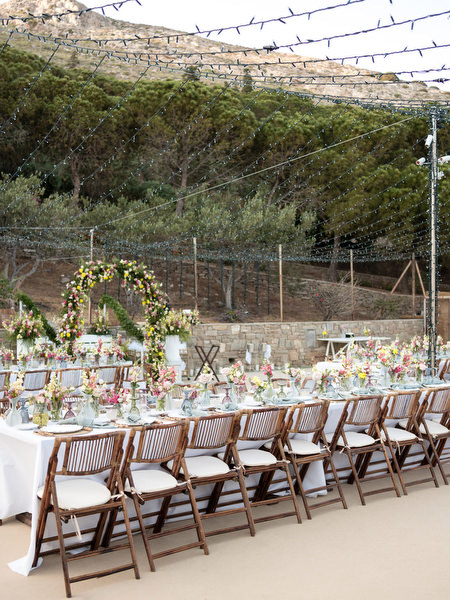 Petra Farm reception space overlooking Paros hills during sunset wedding dinner.