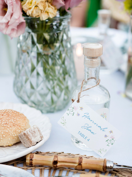 Custom wedding favor bottle displayed on table at Petra Farm Paros reception.