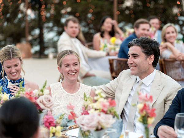 Bride and groom smiling during sunset dinner at Petra Farm Paros.