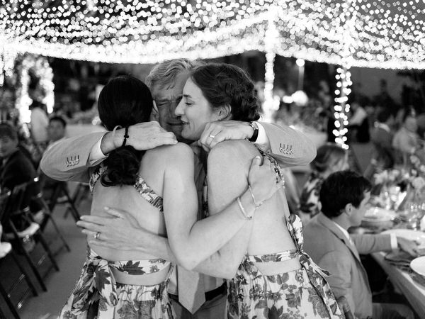 Guests dancing energetically at Paros destination wedding reception.