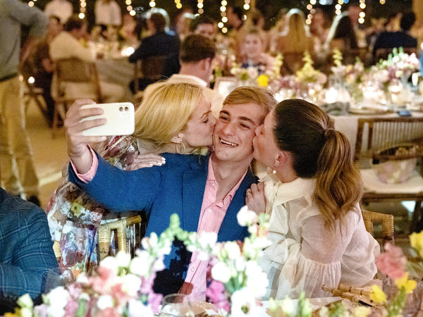Guests taking selfie at Paros destination wedding reception.