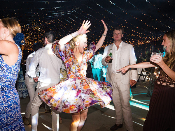 Wedding guest twirling on dance floor at Paros destination wedding reception.