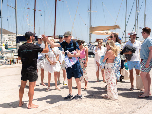Guests hugging and greeting before Paros sailing celebration
