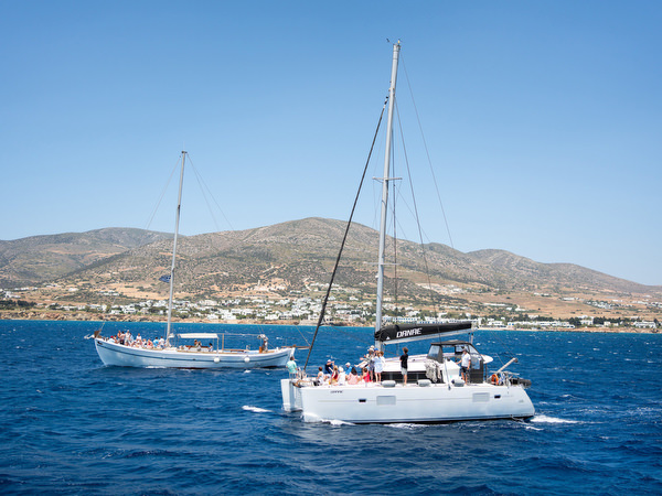 Catamaran sailing across turquoise waters near Paros island