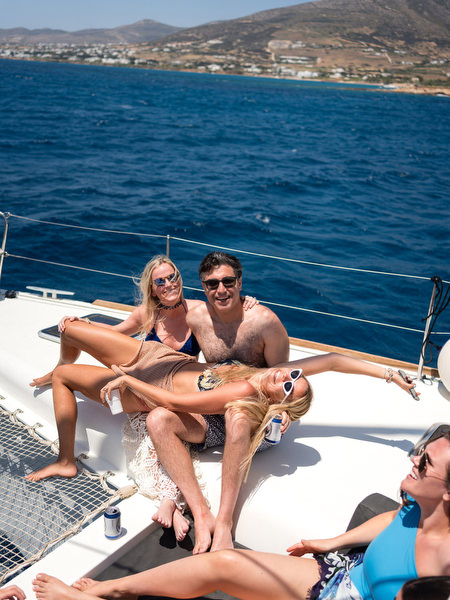 Couple relaxing together on catamaran bow in Paros