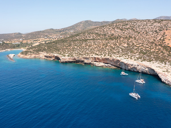 Aerial view of sailboats anchored in turquoise water near Paros