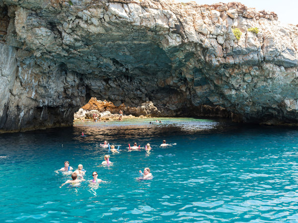 Friends swimming together during Paros wedding boat excursion