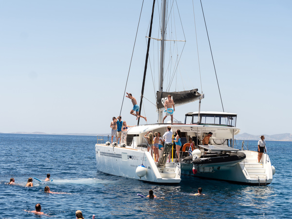 Catamaran anchored in hidden bay during Paros sailing day
