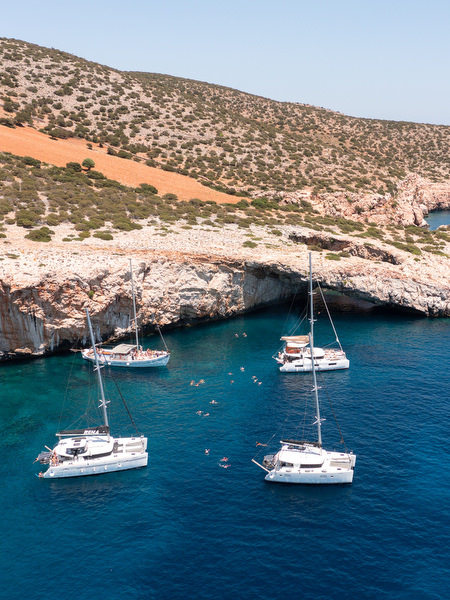 Sailboats anchored in turquoise bay near Paros island