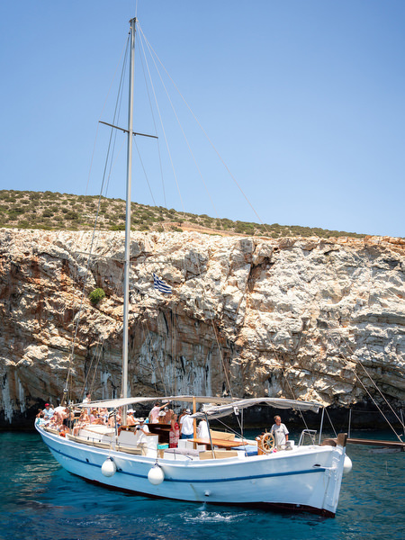 Boat sailing along Paros coastline during wedding weekend
