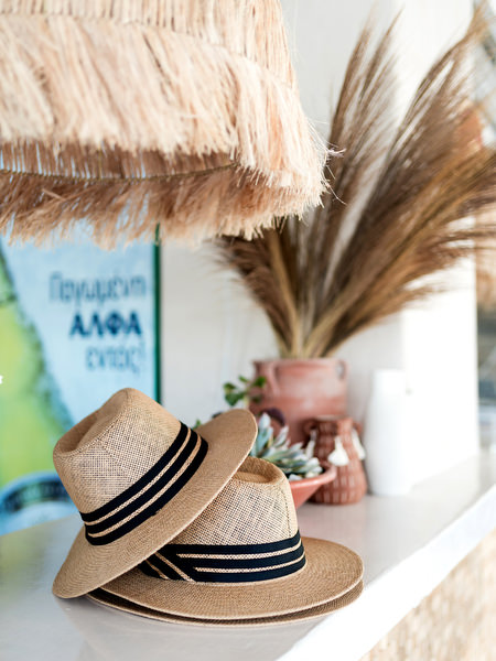 Wedding welcome decor with raffia hat and menu at Monastiri Beach Paros